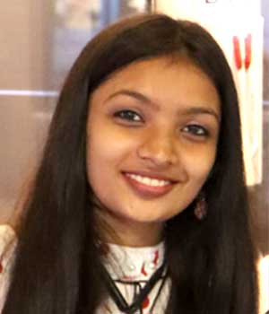 A portrait of Ms. Krina C. Goda, an alumnus of the institution, captured in a professional photograph against a neutral backdrop
