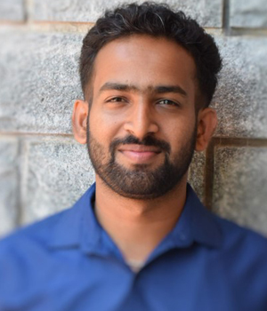 A portrait of Mr. Shrinath Bhat, an alumnus of the institution, captured in a professional photograph against a neutral backdrop